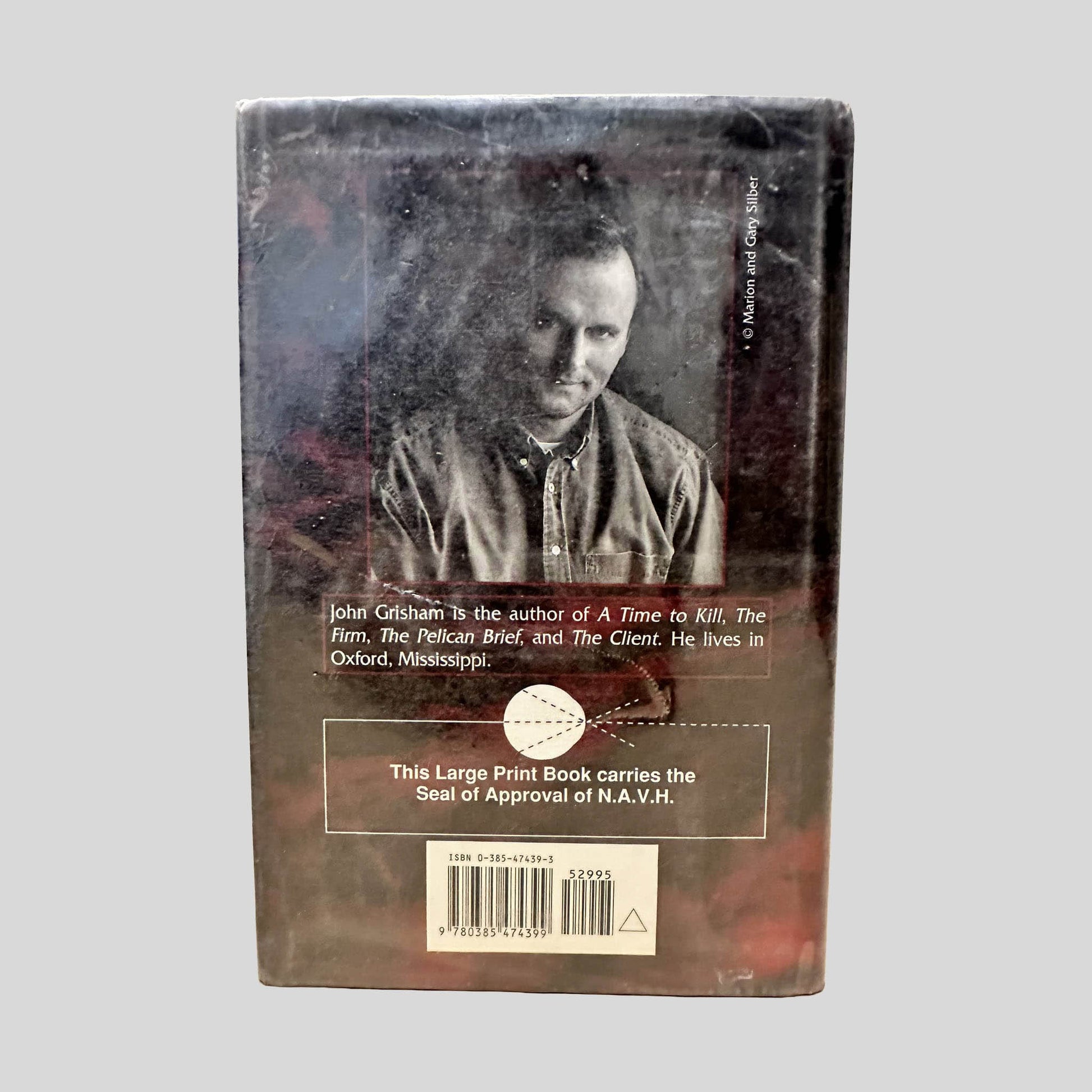Back cover view of The Chamber by John Grisham (Large Print Edition) centered on a neutral light gray background. Mylar covered dust jacket is present. Visible shelf wear.