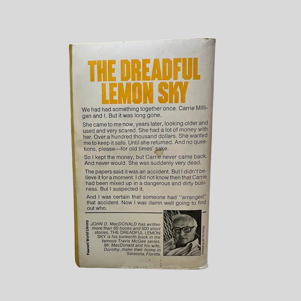 Back cover view of The Dreadful Lemon Sky by John D. MacDonald centered on a neutral light gray background. 