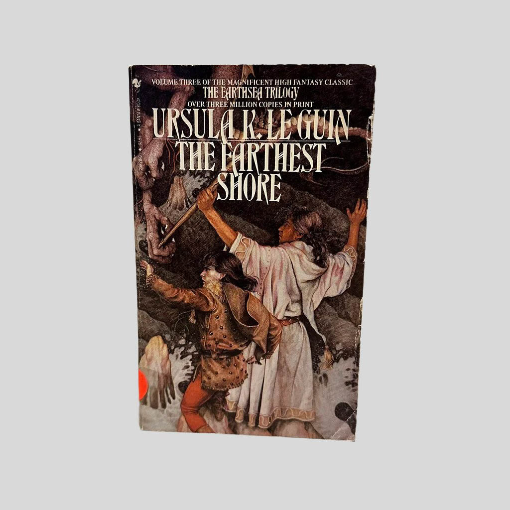 Front cover view of The Farthest Shore by Ursula K. Le Guin centered on a neutral light gray background. Normal chipping around the edges from age. Creasing to the bottom right corner. Cover art is vibrant.