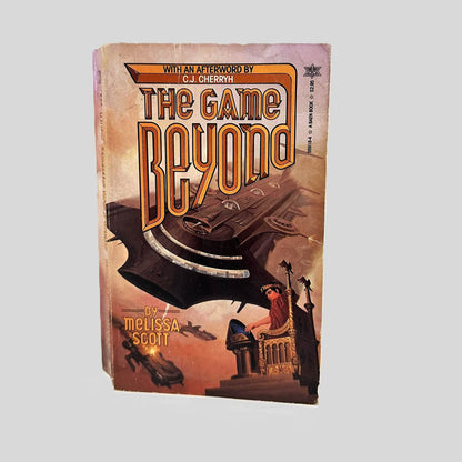Front cover view of The Game Beyond by Melissa Scott centered on a neutral light gray background. Top edge of cover shows chipping. Normal wear for age.