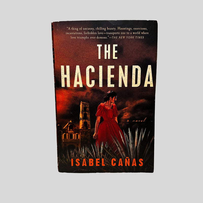 Front cover view of The Hacienda by Isabel Cañas centered on a neutral light gray background.
