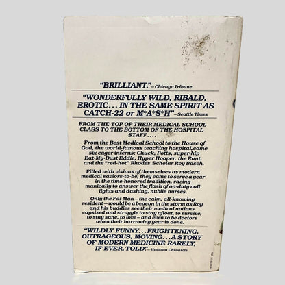 Back cover view of The House of God by Samuel Shem, M.D. centered on a neutral light gray background. Chipping and creasing around the edges. Staining on the top right corner.