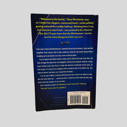 Back cover view of The Housemaid by Freida McFadden centered on a neutral light gray background. Crease along the top and bottom left corners.