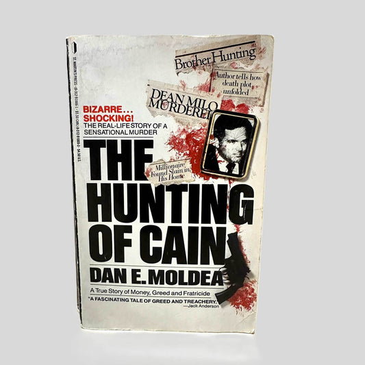Front cover view of The Hunting of Cain by Dan E. Moldea centered on a neutral light gray background. 