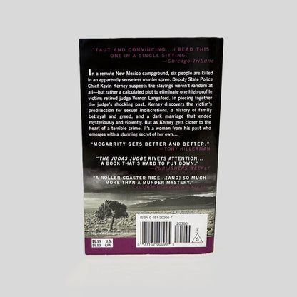 Back cover view of  The Judas Judge by Michael McGarrity centered on a neutral light gray background. Back cover is in pristine condition.