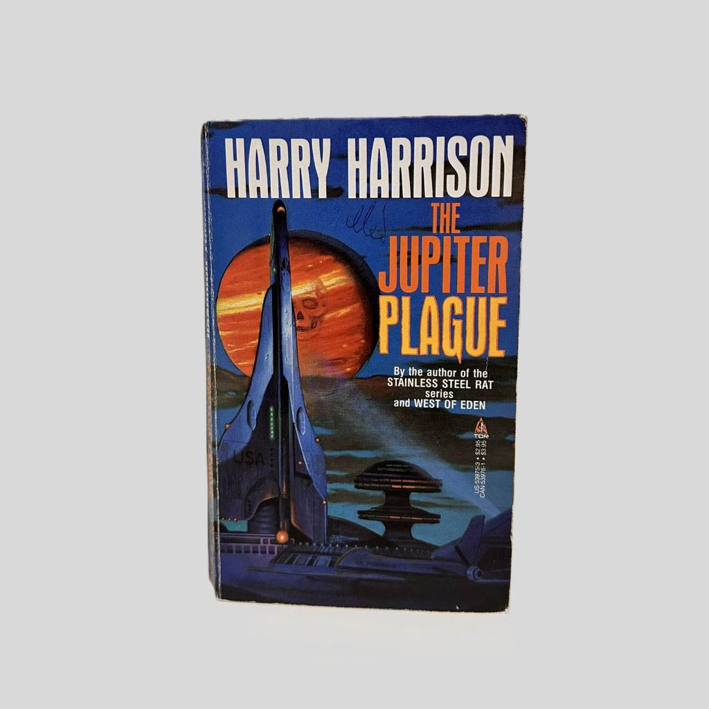Front cover view of The Jupiter Plague by Harry Harrison centered on a neutral light gray background. Creasing near the spine. Chipping in the top right corner. Cover art is vibrant.