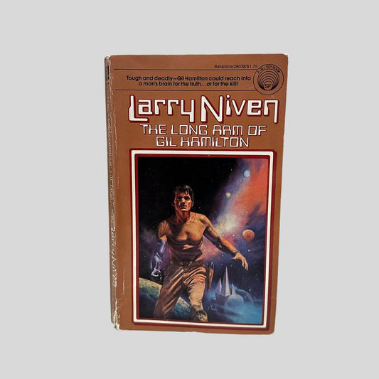 Front cover view of The Long Arm of Gil Hamilton by Larry Niven centered on a neutral light gray background. Chipping and creasing along the spine edge and corners.