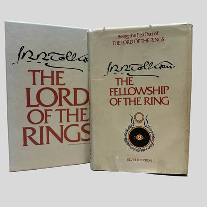 Vintage J.R.R. Tolkien slipcase next to a hardcover copy of 'The Fellowship of the Ring' featuring the iconic Eye of Sauron and red typography.