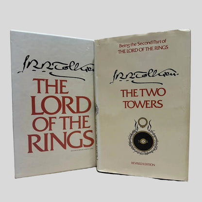 Vintage slipcase for The Lord of the Rings shown with the Revised Edition paperback of 'The Two Towers' by J.R.R. Tolkien. Dust jacket is present and shows creasing along the top edge.