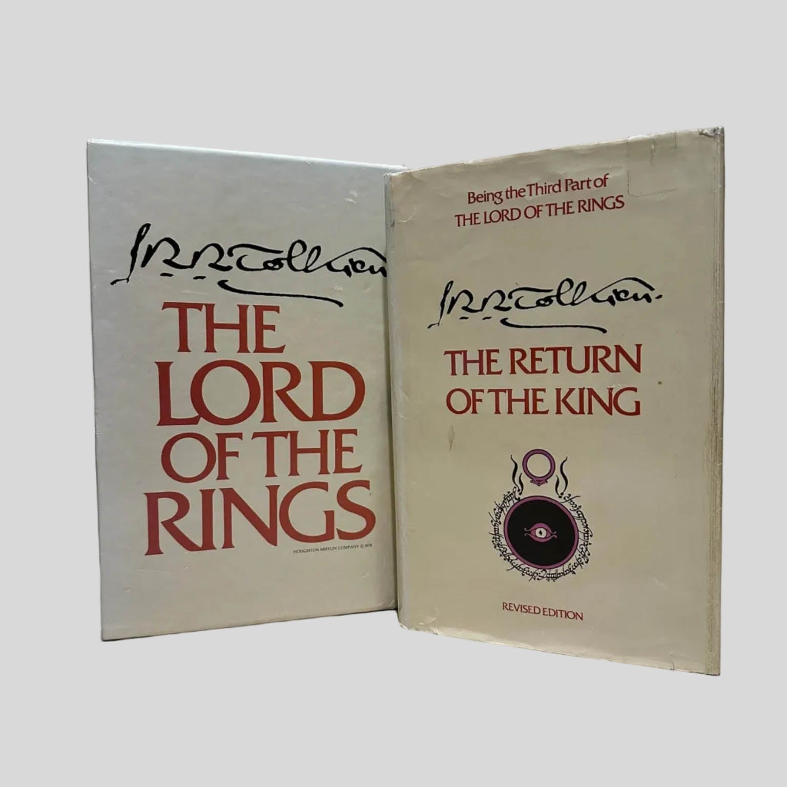 Vintage J.R.R. Tolkien slipcase next to a hardcover copy of 'The Return of the King,' featuring the iconic Eye of Sauron and red typography.
