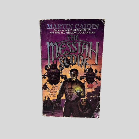 Front cover view of The Messiah Stone by Martin Caidin centered on a neutral light gray background. Cover shows chipping and creasing..