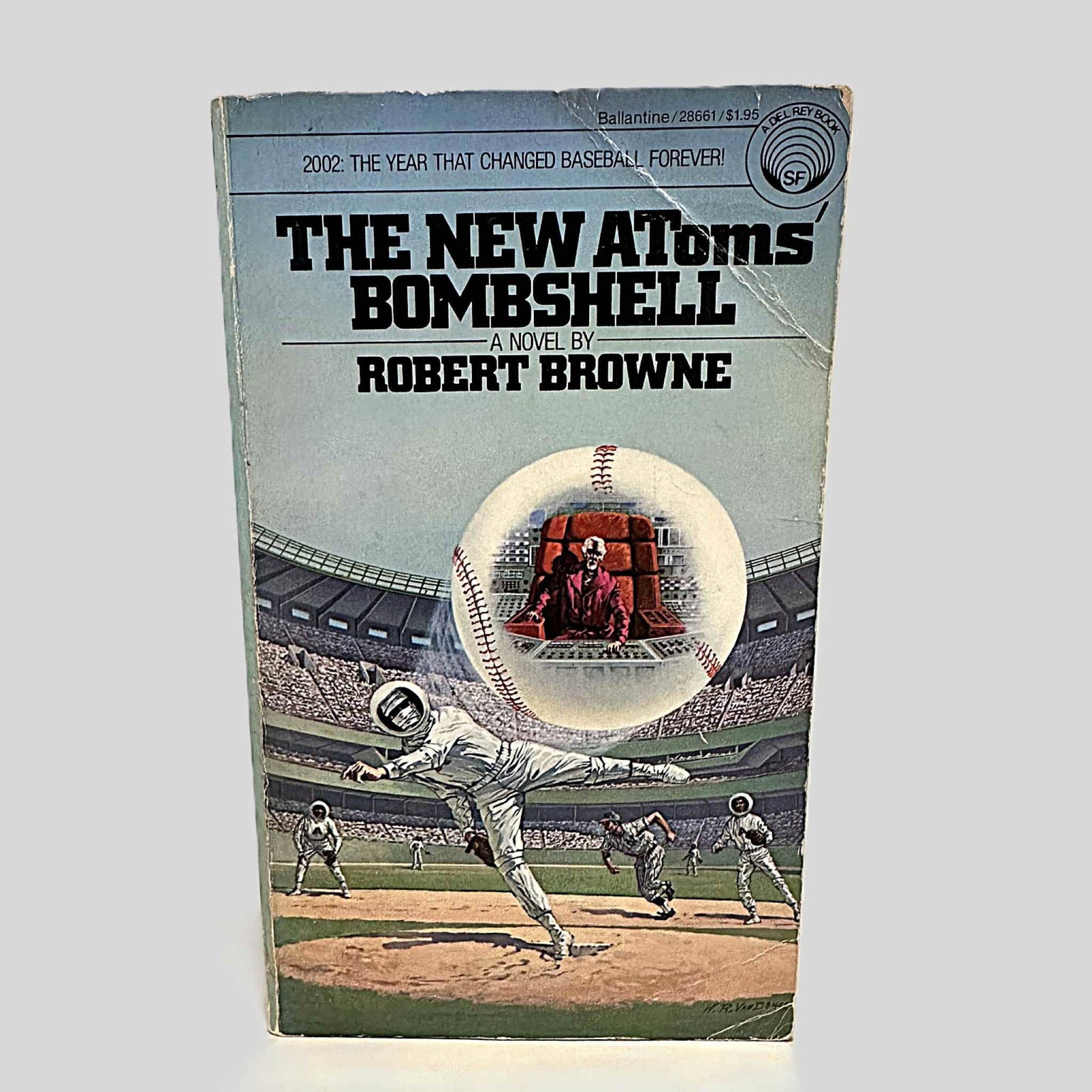 Front cover view of The New Atoms' Bombshell by Robert Browne centered on a neutral light gray background. Creasing across the top and bottom right corners. Chipping is present.