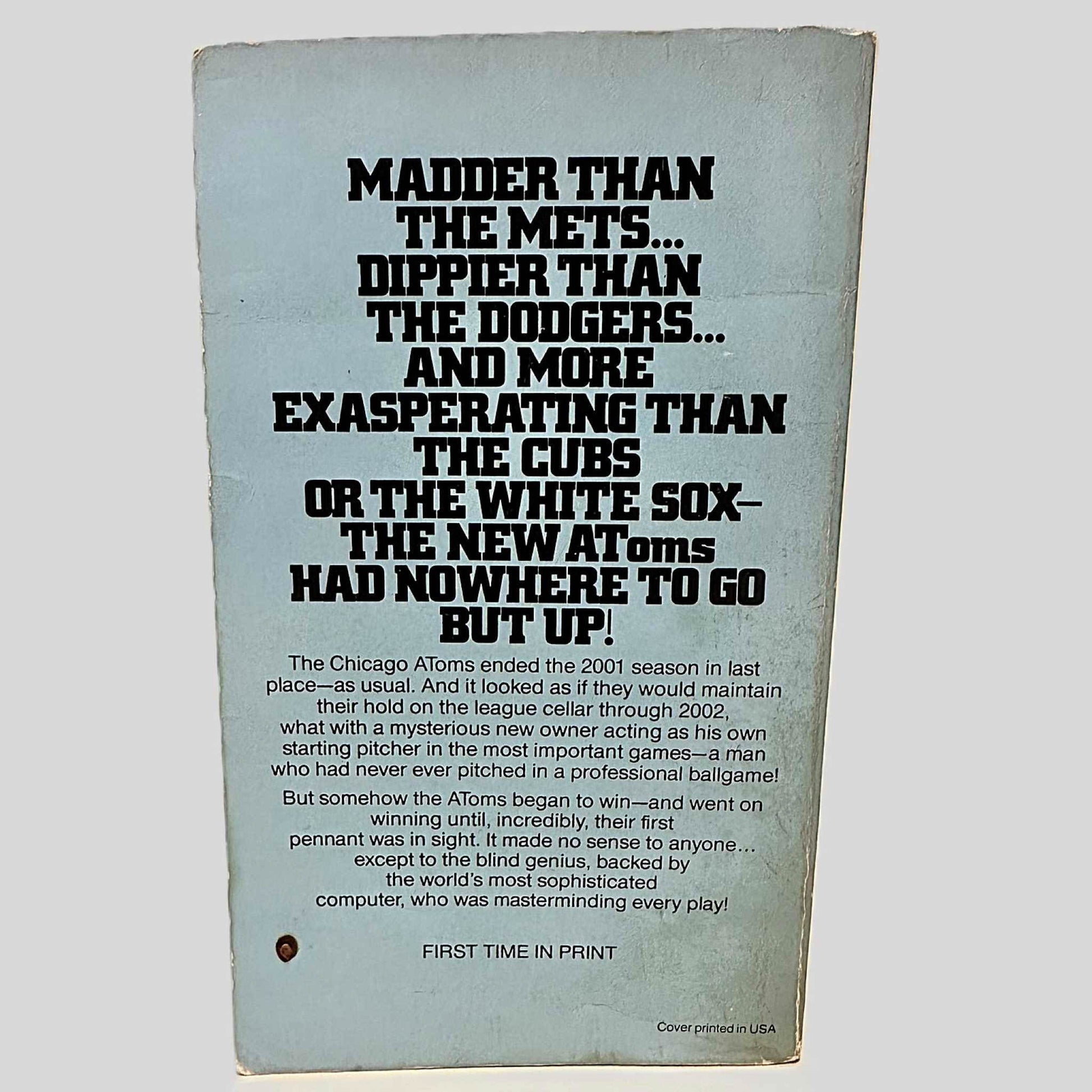 Back cover view of The New Atoms' Bombshell by Robert Browne centered on a neutral light gray background. Chipping and rubbing present.