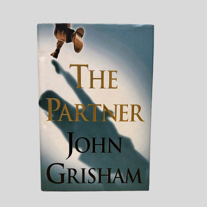 Front cover view of The Partner by John Grisham centered on a neutral light gray background. Dust jacket is present and shows no damage.