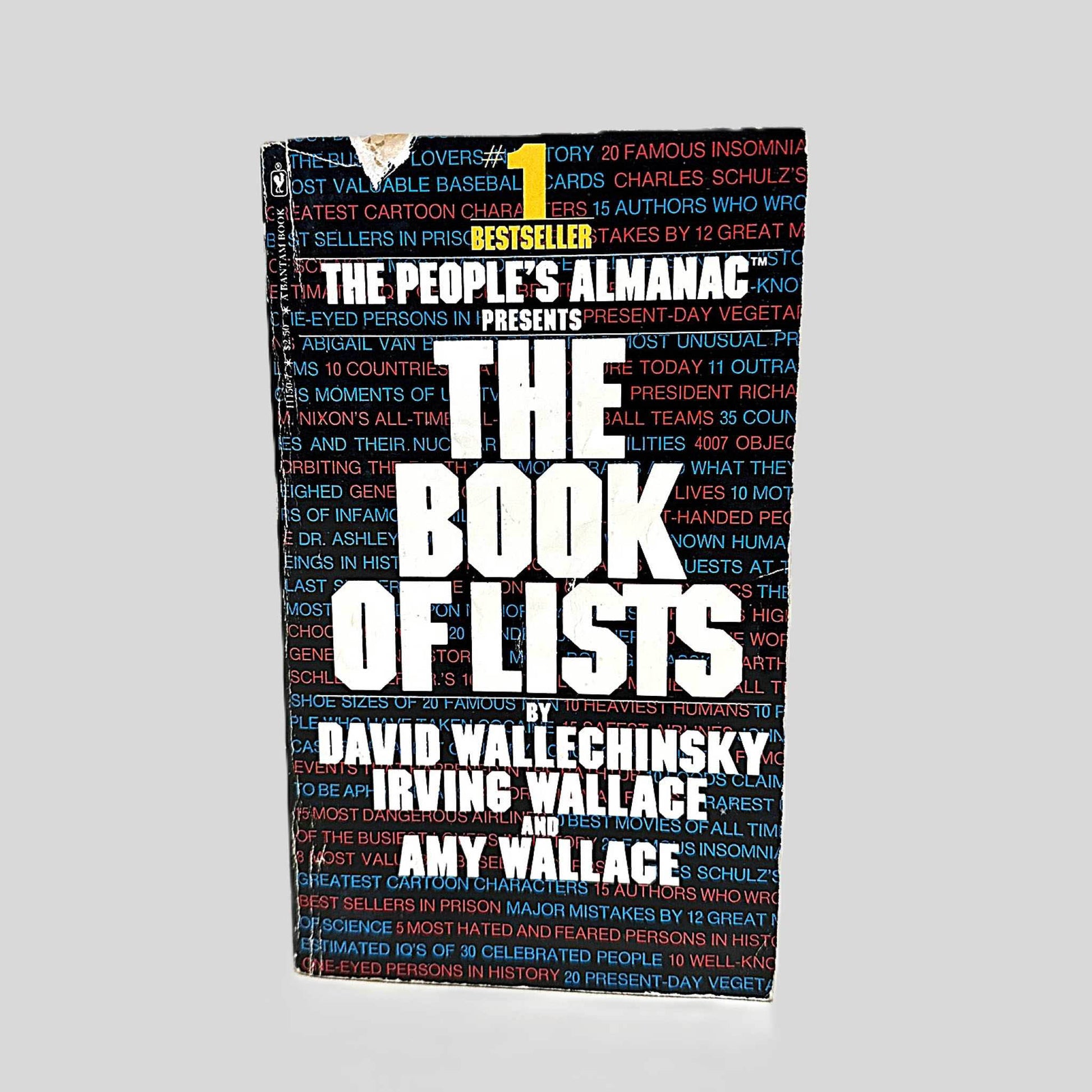Front cover view of The People's Almanac Presents The Book of Lists centered on a neutral light gray background. Tear in the cover near the spine. Creasing present along the spine edge.