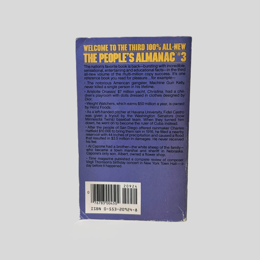 Back cover view of The People's Almanac #3 edited by David Wallechinsky & Irving Wallace centered on a neutral light gray background. Chipping and creasing are present around the edges and corners. 