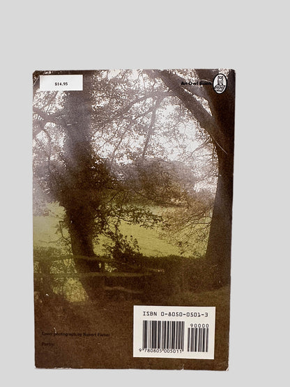 Back cover view of The Poetry of Robert Frost: The Collected Poems, Complete and Unabridged centered on a neutral light gray background. Creasing in the corners.