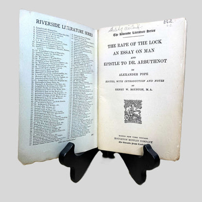 Inside front cover view of The Rape of the Lock by Alexander Pope centered on a neutral light gray background. 