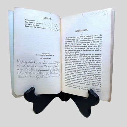 Inside view of "Contents" page and "Introduction" page of The Rape of the Lock by Alexander Pope centered on a neutral light gray background. Notes from a previous owner are written on the "Contents" page in the lower half.