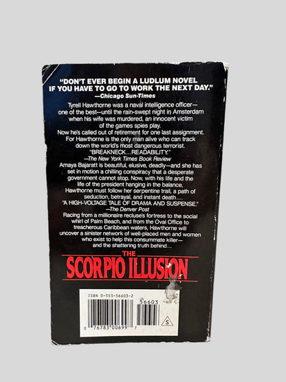 Back cover view of The Scorpio Illusion by Robert Ludlum centered on a neutral light gray background. Chipping around the edges of the back cover. Crease on the tip of the left top corner.