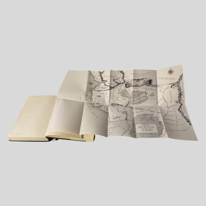 The sprawling, hand-drawn Map of Beleriand unfolds from the back of this vintage The Silmarillion edition. The screen captures the intricate coastal lines and mountain ranges of Middle-earth's First Age in classic black-and-red ink. 