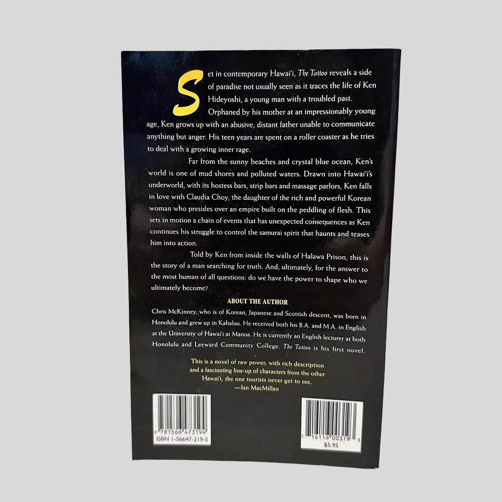 Back cover view of The Tattoo by Chris McKinney centered on a neutral light gray background. 