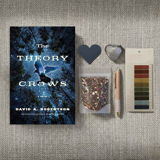 This atmospheric flat lay celebrates the ritual of a "Reader’s Retreat," blending Highland comfort with Dark Academia curiosity. Surrounding the starlit imagery of The Theory of Crows is a pouch of wild botanical tea and a silver heart-shaped infuser, suggesting a warm brew for a cold, mist-covered morning. With its rose-gold pen and leather heart memento, the bundle feels like a collection of treasures gathered from a rugged landscape, inviting a sensory dive into ancestral stories and natural mystery.