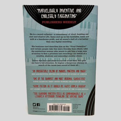 Back cover view of The Vinyl Detective by Andrew Cartmel centered on a neutral light gray background. 