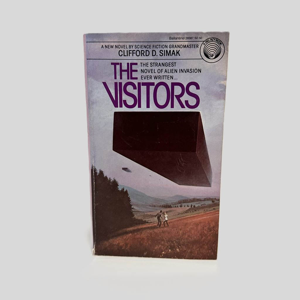 Front cover view of The Visitors by Clifford D. Simak centered on a neutral light gray background. Creasing near the spine and top right corner.
