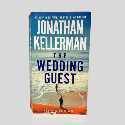 Front cover view of The Wedding Guest by Jonathan Kellerman centered on a neutral light gray background. Chipping is present along the bottom edge of the front cover.