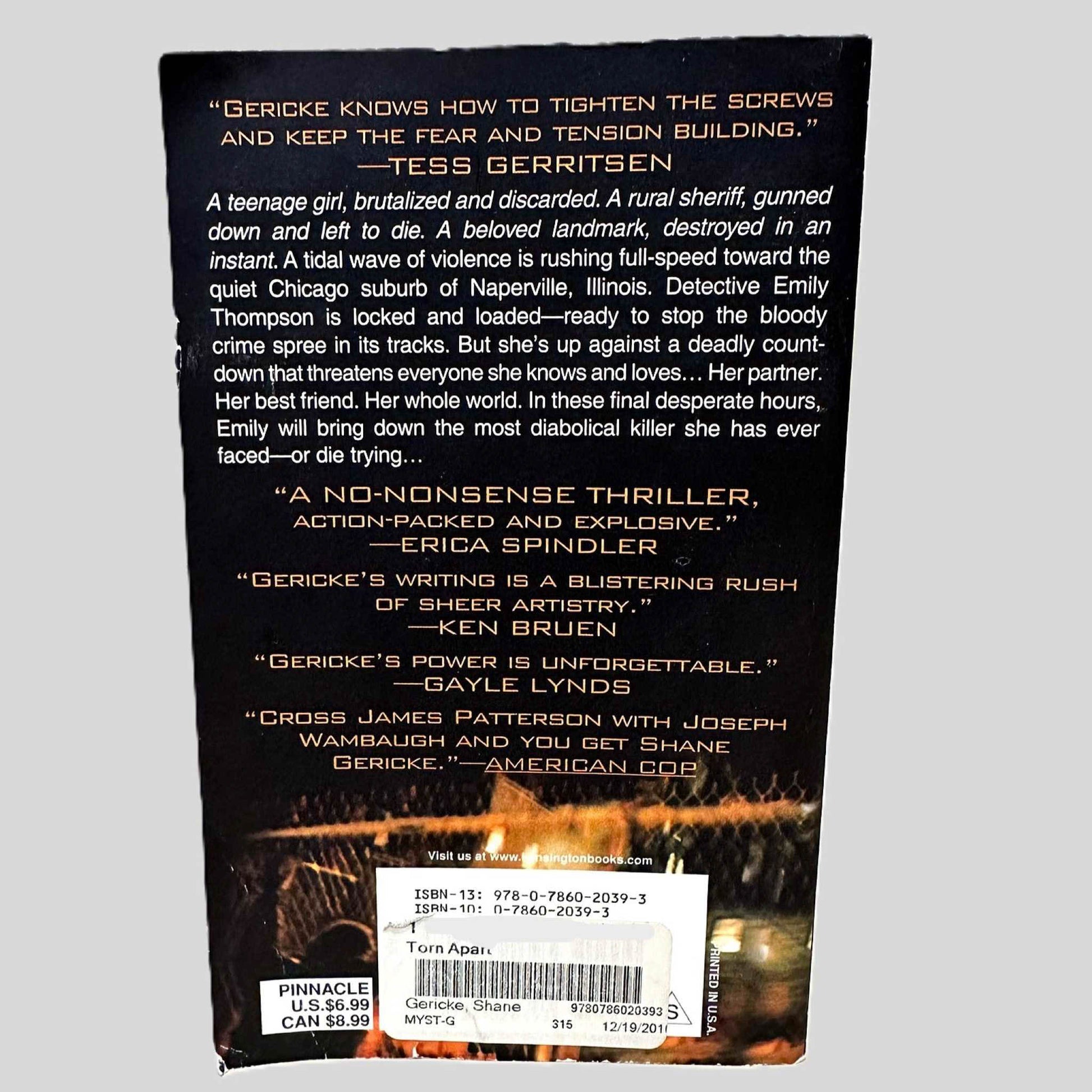 Back cover view of Torn Apart by Shane Gericke centered on a neutral light gray background. Shows minor chipping around the cover edges.