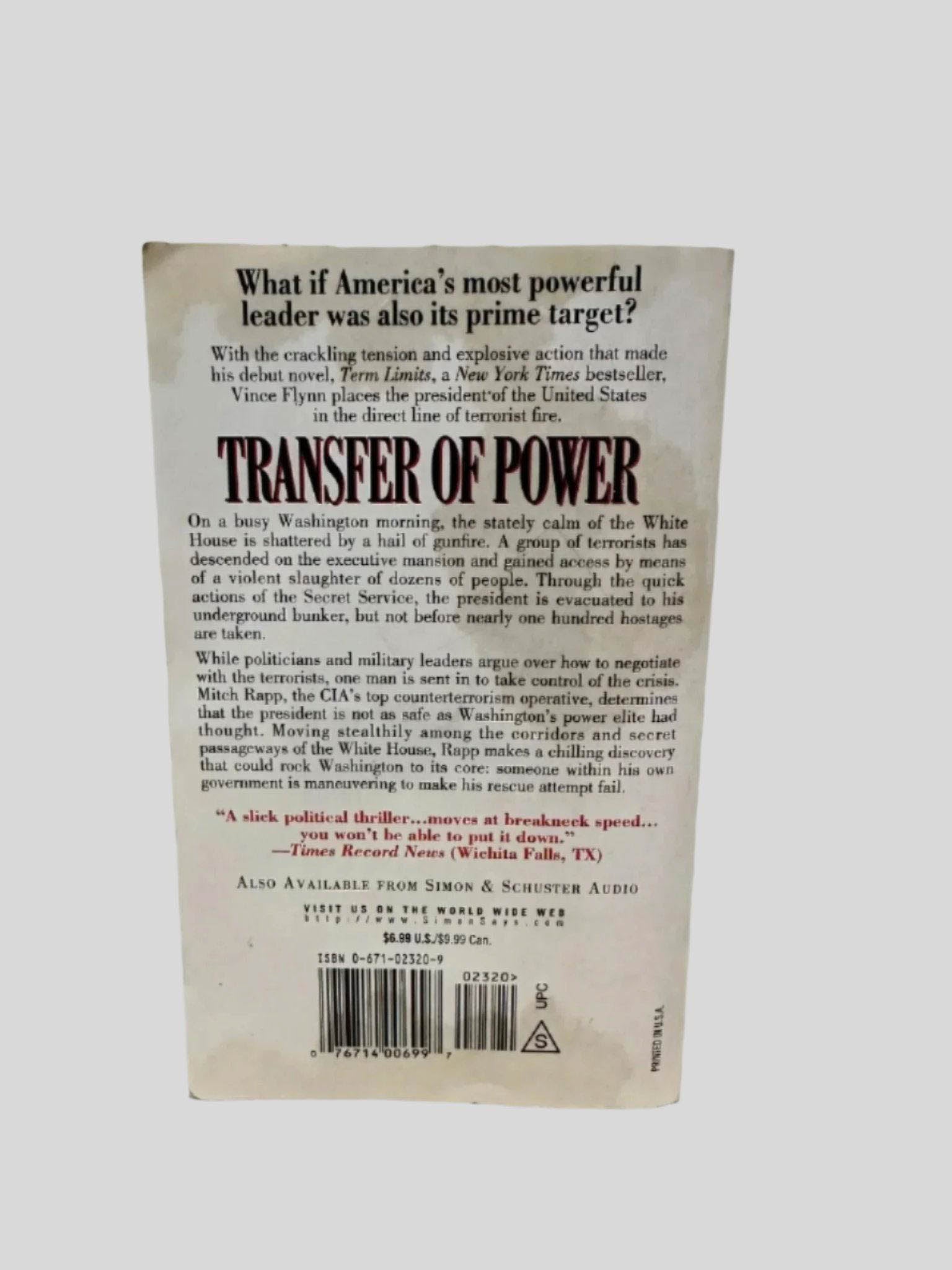 Back cover view of Transfer of Power by Vince Flynn centered on a neutral light gray background. Some staining along the top and bottom edges of cover.