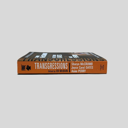 Close-up spine view of Transgressions Vol. 4 Edited by Ed McBain centered on a neutral light gray background. Spine is square and shows no creasing.