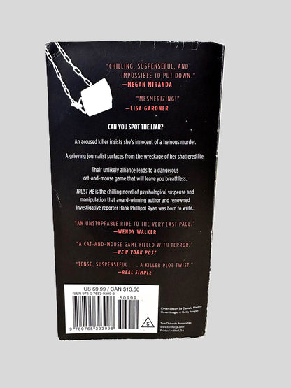Back cover view of Trust Me by Hank Phillippi Ryan centered on a neutral light gray background. Chipping and creasing are present.