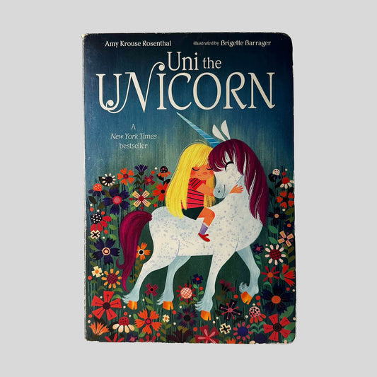 Front cover view of Uni the Unicorn by Amy Krouse Rosenthal centered on a neutral light gray background. Chipping is present around the edges from normal wear.