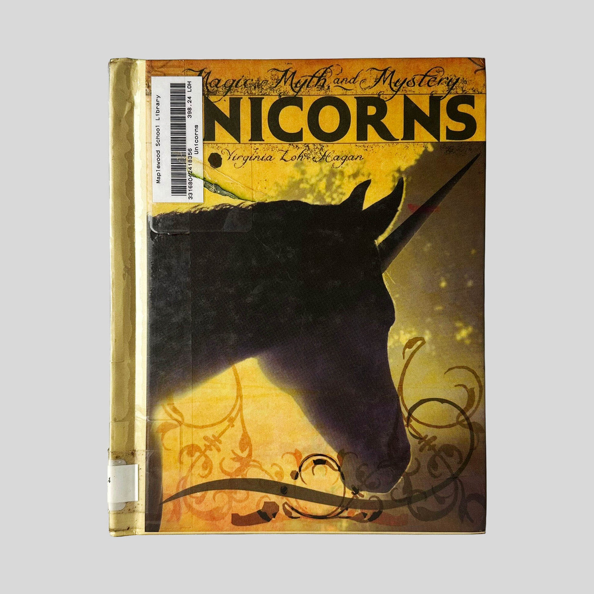 Front cover view of Unicorns by Virginia Loh Hagan centered on a neutral light gray background. Library barcode sticker in the top right corner near the spine from "Maplewood School Library." Top spine shows bumping.