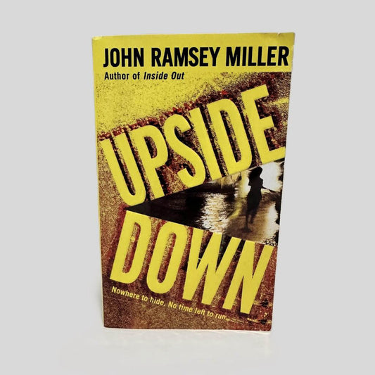 Front cover view of Upside Down by John Ramsey Miller centered on a neutral light gray background. 