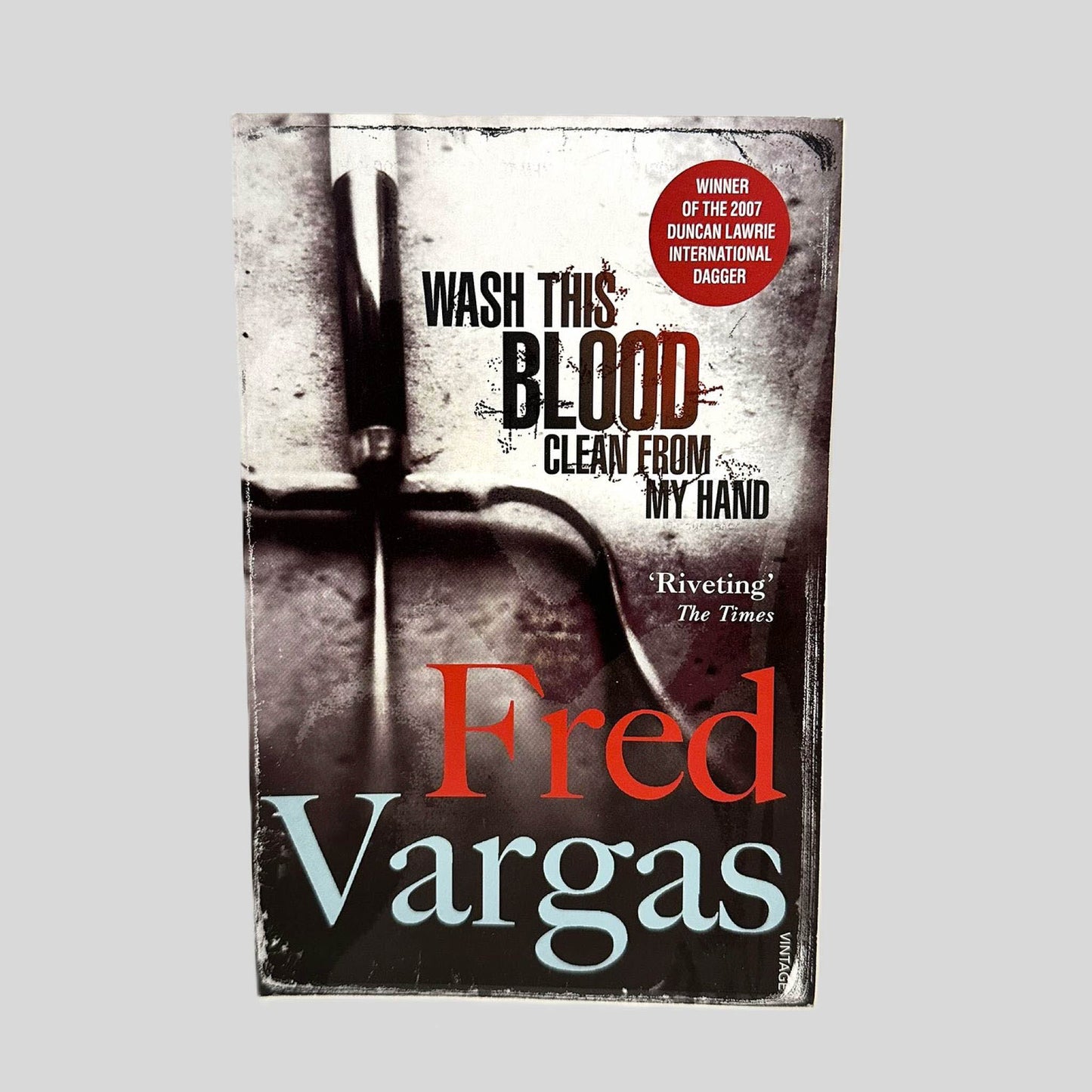Front cover view of Wash This Blood Clean from My Hand Fred Vargas centered on a neutral light gray background. 
