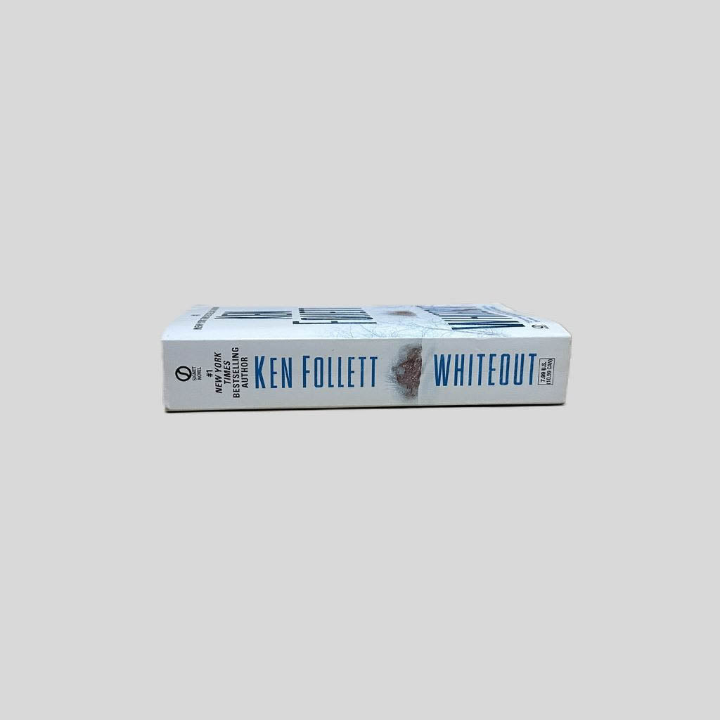 Close-up spine view of Whiteout by Ken Follett centered on a neutral light gray background. Spine is square and shows minimal creasing.