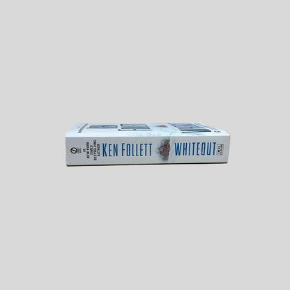 Close-up spine view of Whiteout by Ken Follett centered on a neutral light gray background. Spine is square and shows minimal creasing.