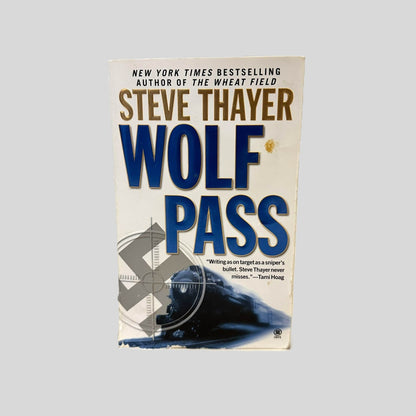 Front cover view of Wolf Pass by Steve Thayer centered on a neutral light gray background. Chipping in the bottom right corner.