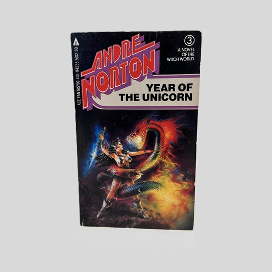 Front cover view of Year of the Unicorn (Witchworld) by Andre Norton centered on a neutral light gray background. Minor chipping to the corners.
