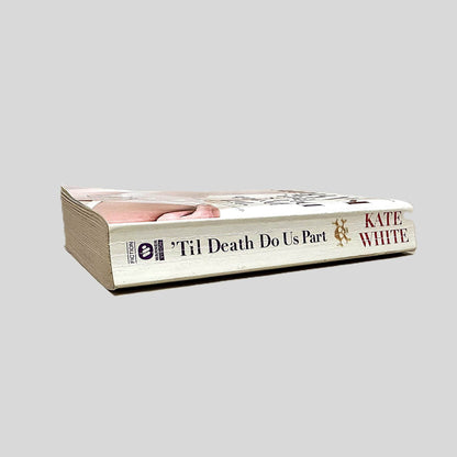 Close-up spine view of 'Til Death Do Us Part by Kate White centered on a neutral light gray background. Spine shows creasing.