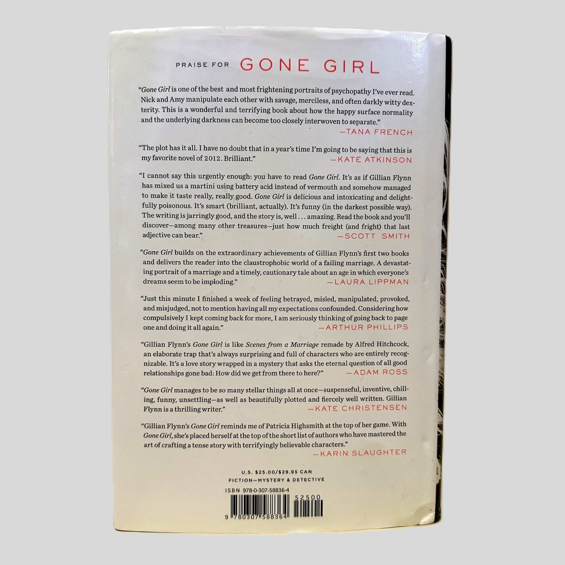 The back cover of the Crown Publishers edition of 'Gone Girl' by Gillian Flynn. The page features a series of glowing reviews under the header 'Praise for Gone Girl' from authors like Tana French, Kate Atkinson, and Karin Slaughter. It captures the tense and suspenseful atmosphere of the novel, describing it as one of the 'most frightening portraits of psychopathy,' documenting the pristine condition of this modern thriller classic.