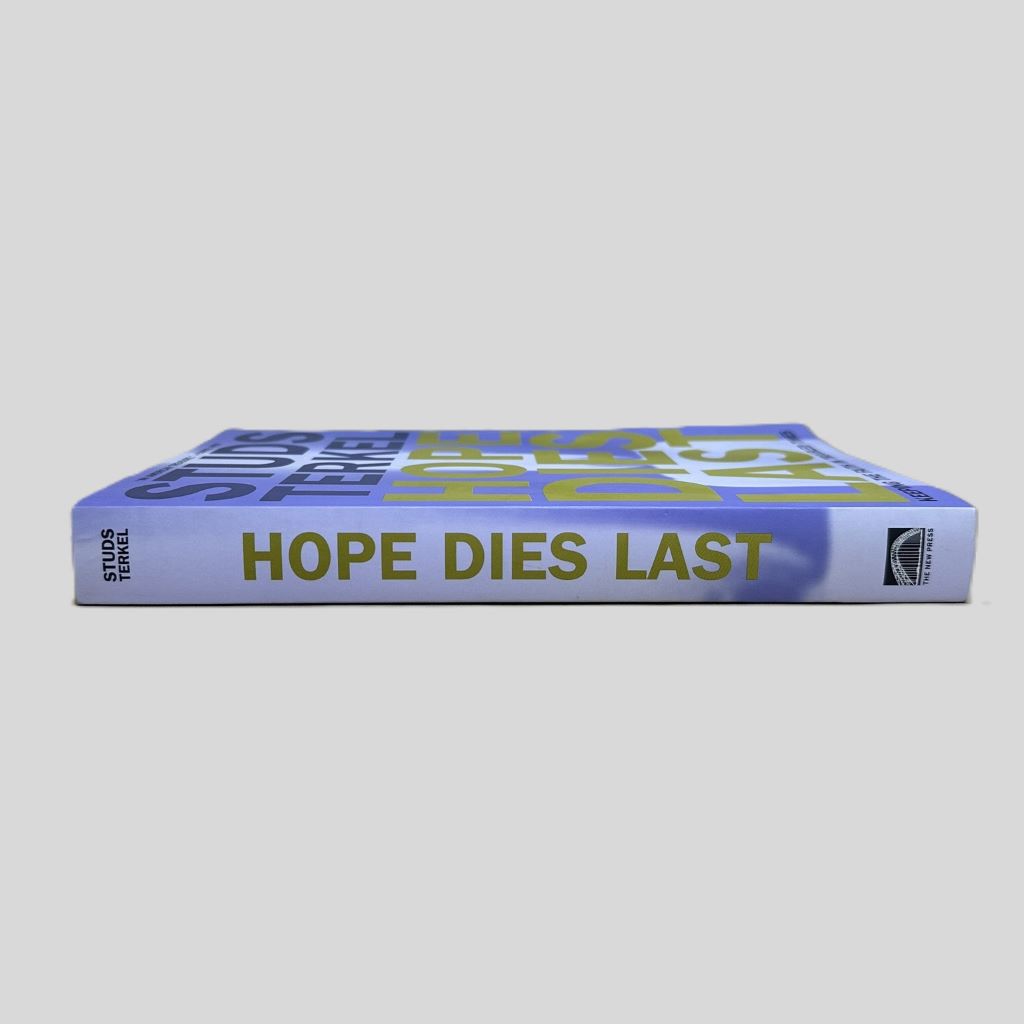 Side view of the paperback book 'Hope Dies Last' by Studs Terkel, showing the purple and blue spine with the title, author's name, and The New Press logo.