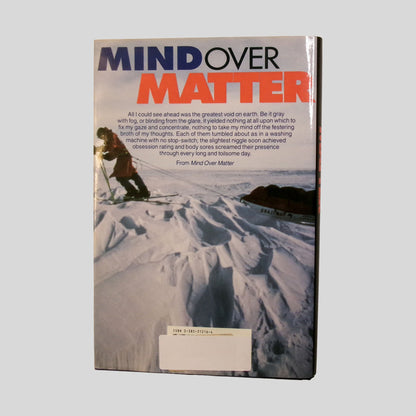 The back cover of "Mind Over Matter" features a stark photograph of the Antarctic landscape, showing explorers in extreme cold-weather gear against a vast field of ice. The screen displays the title in bold blue and red typography above a poignant excerpt describing the human-endurance required to face the "greatest void on earth". This Fehmerling Books selection is an essential hardcover for readers interested in adventure and memoirs.
