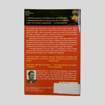 Explore a "gripping account that reads like a suspense novel" with the back cover of "The Lost Tribe," featuring an atmospheric image of a lush jungle canopy. The screen displays a vivid red summary of the Liawep tribe's discovery in Papua New Guinea, alongside praise from Outside Magazine and Norman Lewis. This Fehmerling Books selection is an essential read for fans of travel writing and cultural anthropology.