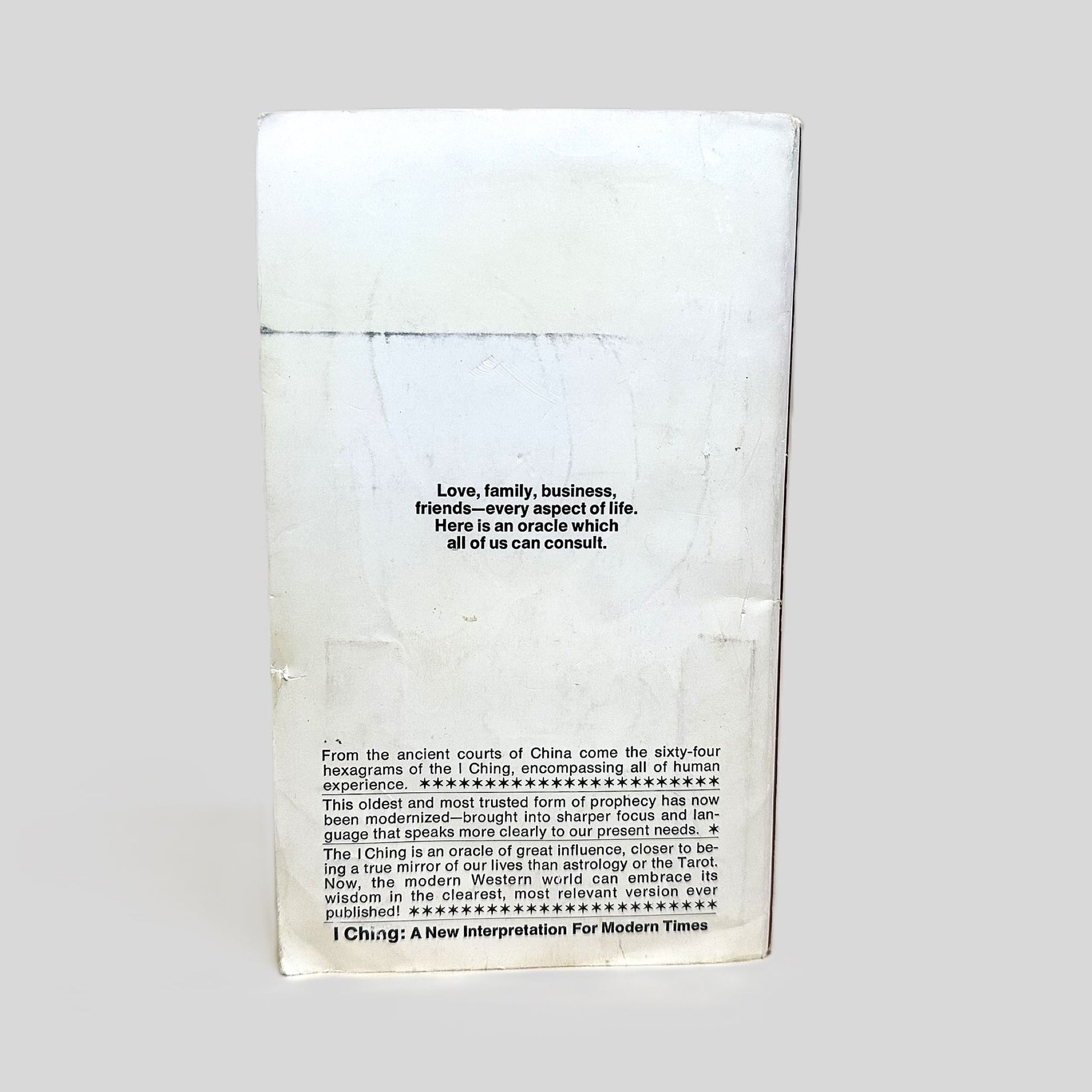 The back cover of the vintage Bantam paperback 'I Ching: A New Interpretation for Modern Times' by Sam Reifler. The weathered white cover features the central quote: 'Love, family, business, friends—every aspect of life. Here is an oracle which all of us can consult'. The detailed blurb explains how the sixty-four hexagrams have been modernized to speak clearly to present needs, offering a true mirror of our lives.