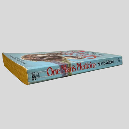 Spine and aged page edges of 'One Man's Medicine' by Morris Gibson, highlighting the book's thickness and the non-fiction category label on the spine.