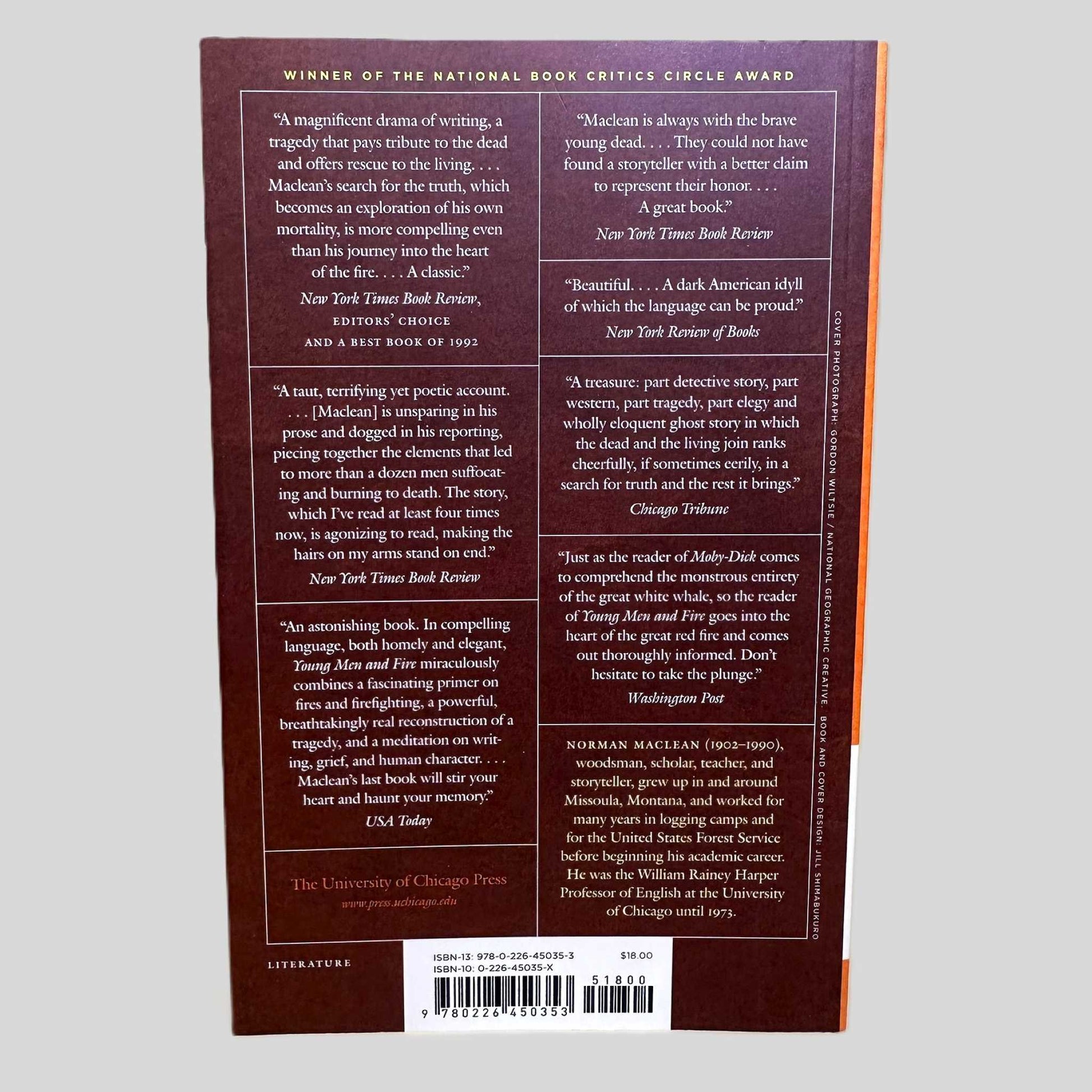 The back cover of the University of Chicago Press edition of 'Young Men and Fire' by Norman Maclean. The dark red cover prominently displays its status as Winner of the National Book Critics Circle Award. It features a comprehensive collection of praise from major publications, including the New York Times Book Review, Chicago Tribune, and USA Today, framing the book as a 'magnificent drama' and a 'part detective story' about the 1949 Mann Gulch tragedy.